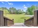 View from back porch featuring a large, green backyard and wooded scenery, providing privacy and a tranquil setting at 93 Clifton Pond Rd, Louisburg, NC 27549