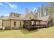 The house showcases a large backyard, wooden deck and pergola, perfect for outdoor enjoyment at 93 Clifton Pond Rd, Louisburg, NC 27549
