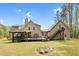 Backyard features a large deck, stairs, and a fire pit, perfect for outdoor enjoyment at 93 Clifton Pond Rd, Louisburg, NC 27549