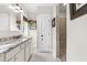 Well-lit bathroom with a granite countertop, white cabinets, tile flooring and a glass door shower at 93 Clifton Pond Rd, Louisburg, NC 27549