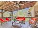 Enjoy the covered deck with wicker furniture, an overhead fan, and views of a wooded backyard at 93 Clifton Pond Rd, Louisburg, NC 27549