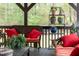 The porch showcases wicker furnishings, plants, and a view of the wooded lot at 93 Clifton Pond Rd, Louisburg, NC 27549