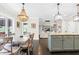 Dining area showcases an elegant chandelier, a large dining table, and views to kitchen and living spaces at 93 Clifton Pond Rd, Louisburg, NC 27549
