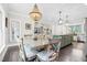 Dining area showcases an elegant chandelier, a large dining table, and views to kitchen and living spaces at 93 Clifton Pond Rd, Louisburg, NC 27549