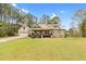 Beautifully landscaped home with a large front yard and inviting porch at 93 Clifton Pond Rd, Louisburg, NC 27549