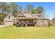 Charming home with a welcoming front porch, beautiful lawn, and attached garage providing a perfect blend of comfort and style at 93 Clifton Pond Rd, Louisburg, NC 27549