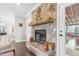 Rustic stone fireplace with a wooden mantel and decorative accents at 93 Clifton Pond Rd, Louisburg, NC 27549