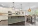 Spacious kitchen features a large island, stainless steel appliances, and stylish pendant lighting at 93 Clifton Pond Rd, Louisburg, NC 27549