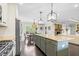 Spacious kitchen features a large island, stainless steel appliances, and views to dining and living areas at 93 Clifton Pond Rd, Louisburg, NC 27549