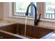Kitchen sink close-up highlights the bronze faucet and granite countertop with a window above at 93 Clifton Pond Rd, Louisburg, NC 27549