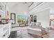 Inviting living area with a soaring ceiling, large windows, and comfortable seating, creating a serene and stylish atmosphere at 93 Clifton Pond Rd, Louisburg, NC 27549