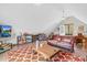 Cozy upstairs living room area with a fireplace, sofa, and outdoor balcony access at 93 Clifton Pond Rd, Louisburg, NC 27549