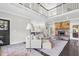 Bright, open-concept living area with a stone fireplace, expansive staircase, and seamless flow for modern living and entertaining at 93 Clifton Pond Rd, Louisburg, NC 27549