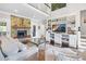Spacious living room with stone fireplace, soaring ceilings, and built-in bookshelves, ideal for gathering and relaxation at 93 Clifton Pond Rd, Louisburg, NC 27549