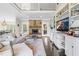 Open-concept living space features a stone fireplace, high ceilings, built-in shelving offering an ideal space for relaxation at 93 Clifton Pond Rd, Louisburg, NC 27549
