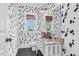 Powder room features unique wallpaper, granite countertop vanity, and stylish fixtures at 93 Clifton Pond Rd, Louisburg, NC 27549
