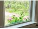 Close-up of window with flowers showing nature scenery outside at 93 Clifton Pond Rd, Louisburg, NC 27549