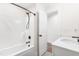 Contemporary bathroom featuring a bathtub with a shower, sleek white vanity, and modern fixtures at 95 Watermeadow Dr, Clayton, NC 27520
