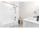 Well-lit bathroom featuring a subway tiled shower-tub, modern fixtures, and a sleek white vanity at 95 Watermeadow Dr, Clayton, NC 27520