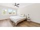 Bright bedroom with hardwood floors, neutral walls, and a ceiling fan, offering a tranquil retreat at 95 Watermeadow Dr, Clayton, NC 27520