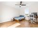 Neutral bedroom with ceiling fan, great light, small bed and a desk at 95 Watermeadow Dr, Clayton, NC 27520