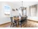 Dining room featuring wood-look floors, lots of natural light, and modern chandelier at 95 Watermeadow Dr, Clayton, NC 27520