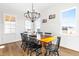 Bright dining room with chandelier, wood-look floors, neutral walls, and windows at 95 Watermeadow Dr, Clayton, NC 27520