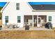 Back exterior of home with screened porch, outdoor seating and grill, and large backyard at 95 Watermeadow Dr, Clayton, NC 27520
