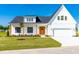 Charming two-story home with a well-manicured lawn, wood accents, and classic architectural details at 95 Watermeadow Dr, Clayton, NC 27520