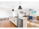 Open concept kitchen with stainless steel appliances, island, and seamless flow to the living area at 95 Watermeadow Dr, Clayton, NC 27520