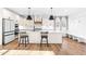 Bright kitchen with white cabinetry, an island with seating, and a cozy breakfast nook at 95 Watermeadow Dr, Clayton, NC 27520