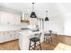 Bright, modern kitchen featuring a center island with a black faucet and stylish pendant lighting at 95 Watermeadow Dr, Clayton, NC 27520