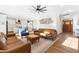 Bright, open-concept living room with hardwood floors, modern ceiling fan, and seamless flow into the kitchen at 95 Watermeadow Dr, Clayton, NC 27520