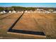 Aerial view of a property showcasing land and its neighborhood, all surrounded by fencing at 95 Watermeadow Dr, Clayton, NC 27520