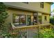 Exterior view of a wooden deck with stairs and black railings leading to the backyard at 103 Windhover Dr, Chapel Hill, NC 27514