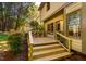 Exterior view of a wooden deck with stairs and black railings leading to the backyard at 103 Windhover Dr, Chapel Hill, NC 27514