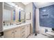 Bathroom featuring a tiled shower with glass doors and a double vanity with modern fixtures and mirrors at 103 Windhover Dr, Chapel Hill, NC 27514