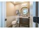 Stylish powder room features updated vanity, round mirror, beadboard and neutral paint for a serene space at 103 Windhover Dr, Chapel Hill, NC 27514