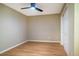 A cozy bedroom featuring hardwood floors, a ceiling fan and an interior closet at 103 Windhover Dr, Chapel Hill, NC 27514