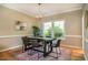 Dining room with a modern light fixture, rug and view to the yard at 103 Windhover Dr, Chapel Hill, NC 27514