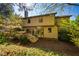 The back of the home featuring a deck, and a lawn surrounded by mature trees at 103 Windhover Dr, Chapel Hill, NC 27514