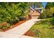 Brick home with a long driveway, mature trees, and manicured lawn, creating a welcoming curb appeal at 103 Windhover Dr, Chapel Hill, NC 27514