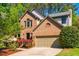 Charming brick home with a two-car garage and mature landscaping at 103 Windhover Dr, Chapel Hill, NC 27514
