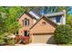 Charming brick home with a two-car garage and mature landscaping at 103 Windhover Dr, Chapel Hill, NC 27514