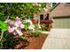 Charming home exterior with well-manicured landscaping featuring blooming flowers and a spacious driveway at 103 Windhover Dr, Chapel Hill, NC 27514