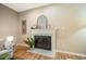 Close up of fireplace featuring a decorative mantle, tile surround, and a black fireplace screen at 103 Windhover Dr, Chapel Hill, NC 27514