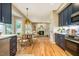 Open kitchen with an adjacent breakfast area, hardwood floors and blue cabinets at 103 Windhover Dr, Chapel Hill, NC 27514