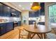 Kitchen with a breakfast nook, stainless appliances, and navy cabinets at 103 Windhover Dr, Chapel Hill, NC 27514