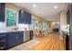 Open concept kitchen showcases blue cabinets, stainless dishwasher and view of dining area and living space at 103 Windhover Dr, Chapel Hill, NC 27514