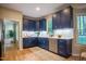 L-shaped kitchen features blue cabinets and stainless steel appliances at 103 Windhover Dr, Chapel Hill, NC 27514